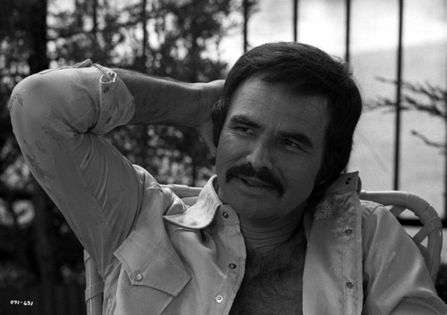 Burt Reynolds wearing an unbuttoned shirt with his hand on his head Photo Print - Item # VARCEL684186