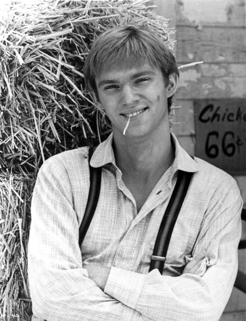 Richard Thomas wearing suspenders in front a hay bale Photo Print - Item # VARCEL684456