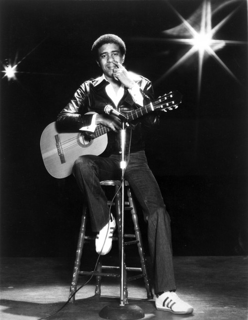 Richard Pryor on stage playing a guitar Photo Print - Item # VARCEL684546