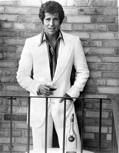 Tony Roberts wearing a suit in front of a brick wall Photo Print - Item # VARCEL684567