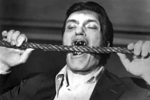 Film still of Richard Kiel biting a cable in The Spy That Loved Me Photo Print - Item # VARCEL684664
