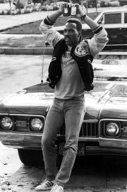 Eddie Murphy holding up a police badge Photo Print - Item # VARCEL684681