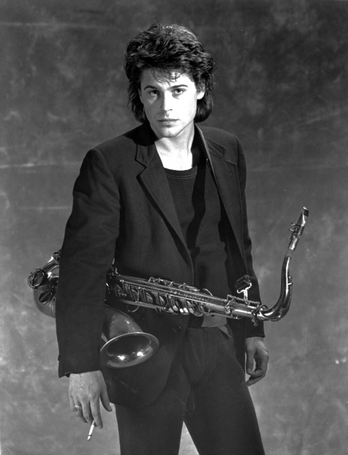 Rob Lowe carrying a saxophone Photo Print - Item # VARCEL684841