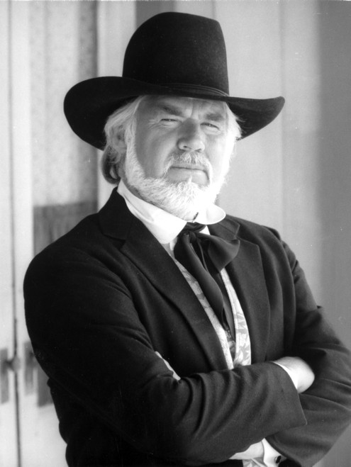 Kenny Rogers with his arms crossed wearing a cowboy hat Photo Print - Item # VARCEL684864