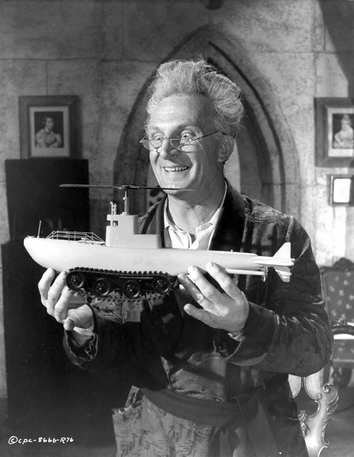 Film still of Emil Stika carrying a model ship Photo Print - Item # VARCEL684883