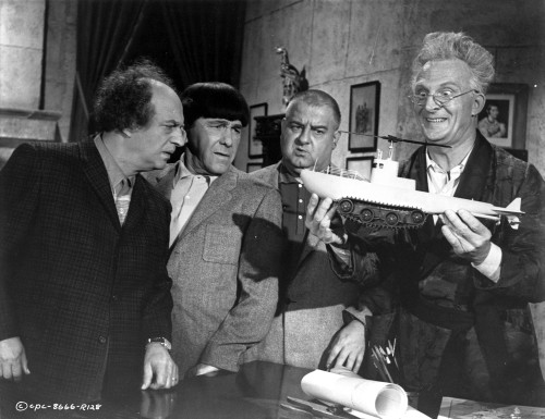 Film still of Emil Stika carrying a model ship and co stars Photo Print - Item # VARCEL684887