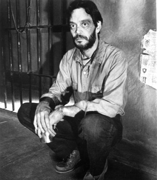 Raul Julia crouching in a prison Photo Print - Item # VARCEL684969