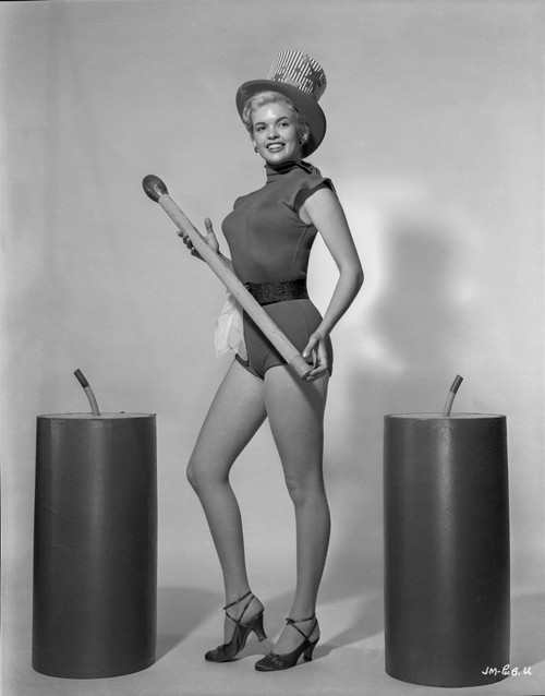 Jayne Mansfield Posed in Black One Piece Velvet Sexy Suit and Black Waist Belt with Hands Holding a Wood Baton and Right Foot Forward in Black High Heel Sandals Photo Print - Item # VARCEL685385