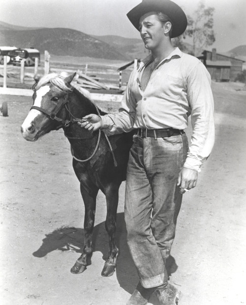 Film still featuring Robert Mitchum as a cowboy Photo Print - Item # VARCEL686044