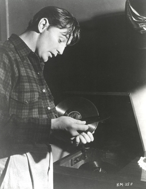 Film still featuring Robert Mitchum holding records Photo Print - Item # VARCEL686070