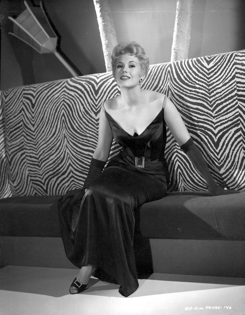 Kim Novak Siting on Couch in Black Gown Portrait Photo Print - Item # VARCEL686505