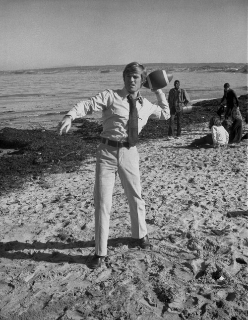 Robert Redford Playing Football at the Beach Photo Print - Item # VARCEL687068