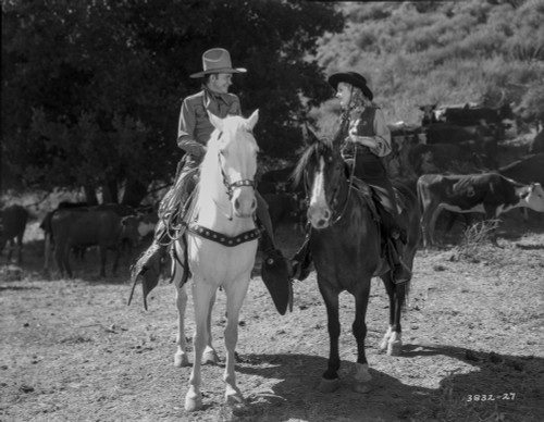 Tex Ritter and an actress on horseback Photo Print - Item # VARCEL687116