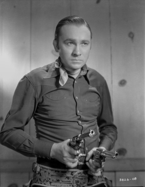Tex Ritter aiming revolvers Photo Print - Item # VARCEL687110