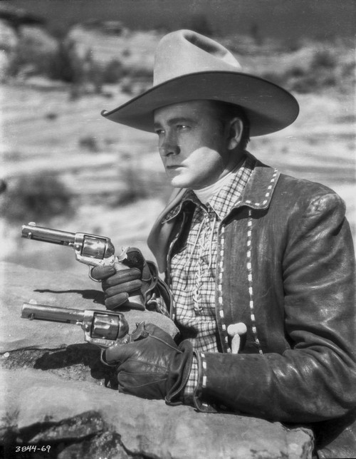 Tex Ritter aiming revolvers Photo Print - Item # VARCEL687111