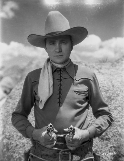 Tex Ritter aiming revolvers Photo Print - Item # VARCEL687129