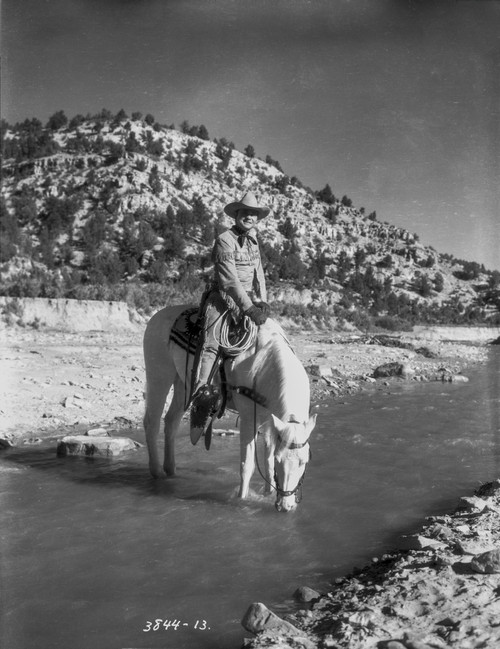 Tex Ritter on horseback in a river Photo Print - Item # VARCEL687131