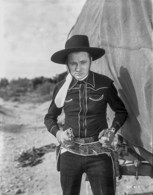 Tex Ritter aiming revolvers Photo Print - Item # VARCEL687134