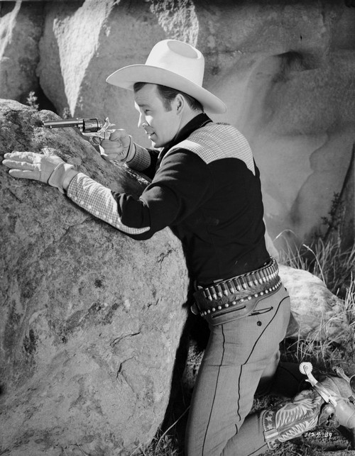 Roy Rogers Pointing A Gun with Cowboy Outfit in Black and White Photo Print - Item # VARCEL687283