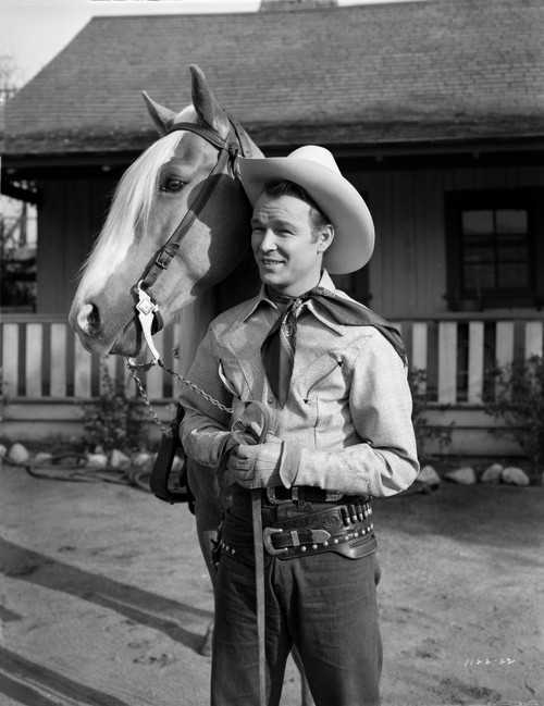 Roy Rogers standing and Holding the Horse's Reins Photo Print - Item # VARCEL687299