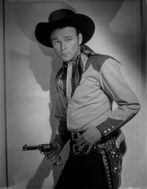 Roy Rogers Leaning on Wall and Holding a Revolver Photo Print - Item # VARCEL687346