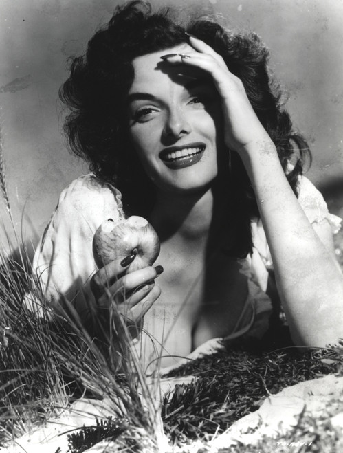 Jane Russell holding an apple Photo Print - Item # VARCEL687421