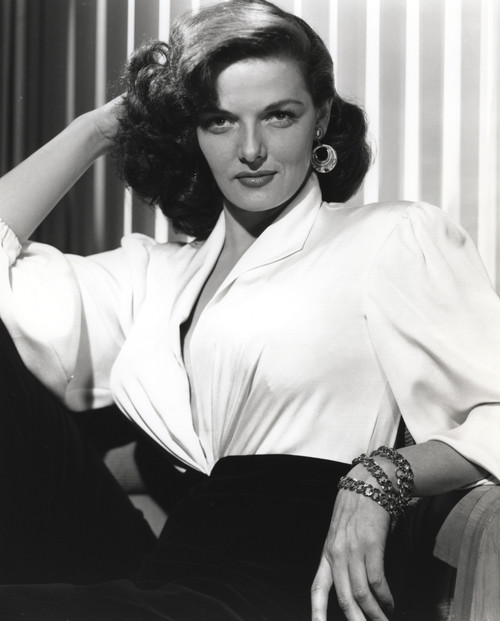 Jane Russell Posed in White Linen V-Neck Dress and Black Linen High Waist Pants with Layered Hoop Earrings while Right Hand Placed Behind the Head Photo Print - Item # VARCEL687480
