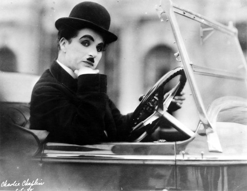 Charlie Chaplin Ridding in Vehicle Photo Print - Item # VARCEL688026