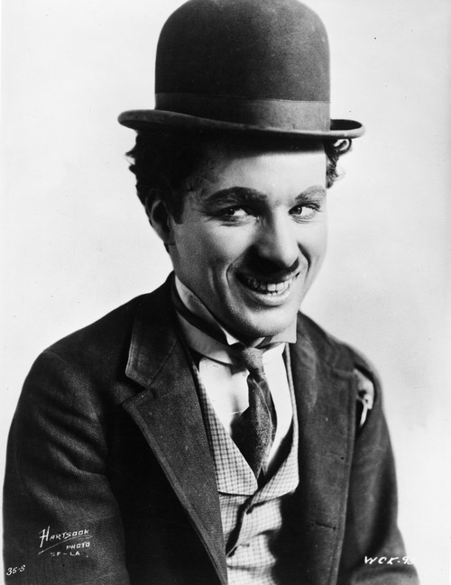 Charlie Chaplin smiling in a Coat and Tie Photo Print - Item # VARCEL688047