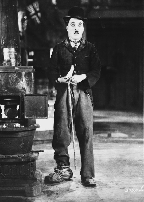 A film still of Charlie Chaplin holding a chain Photo Print - Item # VARCEL688117