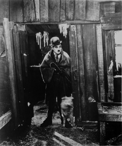A film still of Charlie Chaplin with a dog Photo Print - Item # VARCEL688121