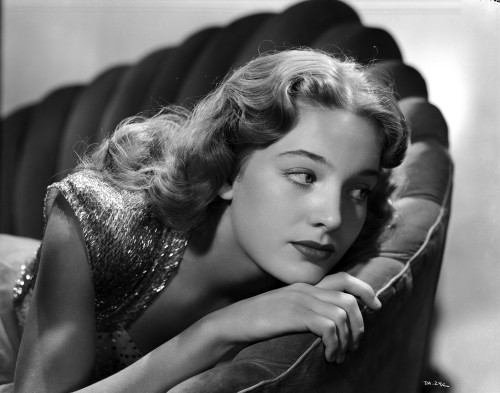 Debra Alden resting on an armchair Photo Print - Item # VARCEL688134