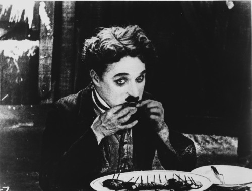 A film still of Charlie Chaplin eating Photo Print - Item # VARCEL688137