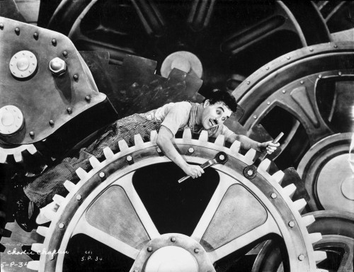 A film still of Charlie Chaplin trapped in machinery Photo Print - Item # VARCEL688145