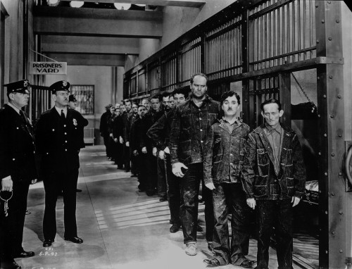 A film still of Charlie Chaplin in a jail Photo Print - Item # VARCEL688153
