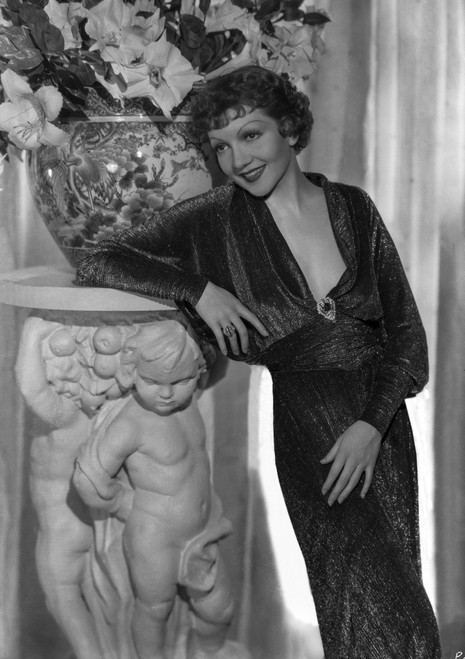 Claudette Colbert Leaning on Statue, wearing Black Dress Photo Print - Item # VARCEL688526