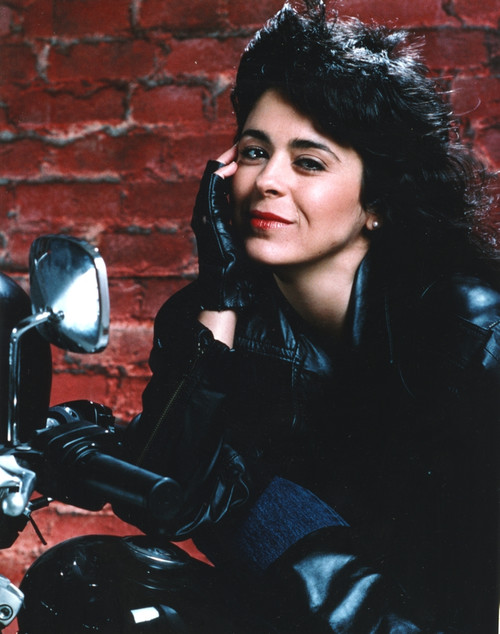 Maria Alonzo Leaning on Motorcycle, wearing Black Leather Jacket with a Smile Photo Print - Item # VARCEL688568