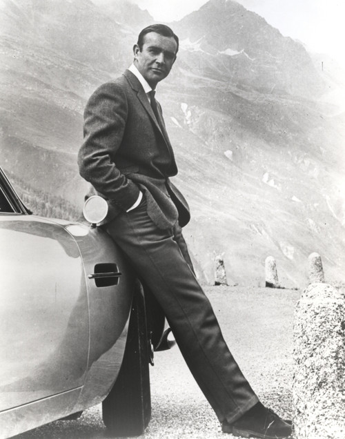 Sean Connery leaning on a car in Goldfinger Photo Print - Item # VARCEL688602
