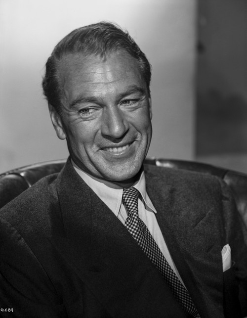 Gary Cooper smiling in Suit, Seated on Couch Photo Print - Item # VARCEL688655