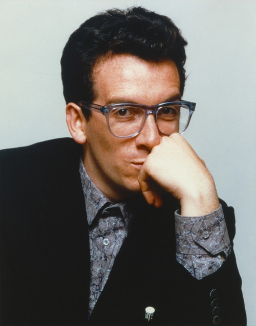Elvis Costello Leaning Chin On Hand in Black Tuxedo Photo Print - Item # VARCEL688705