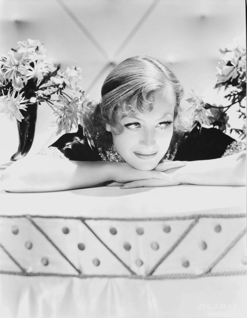 Joan Crawford leaning on a table Photo Print - Item # VARCEL688740
