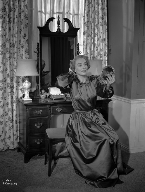Joan Crawford Fixing Her Hair with the Help of a Small Mirror in Classic Photo Print - Item # VARCEL688765