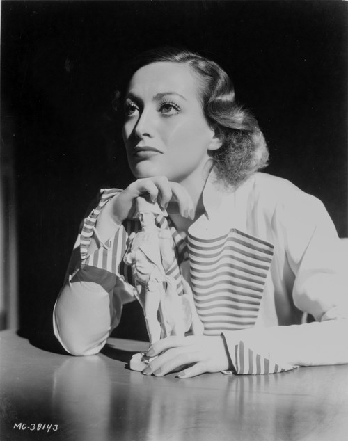 Joan Crawford leaning on a table Photo Print - Item # VARCEL688796