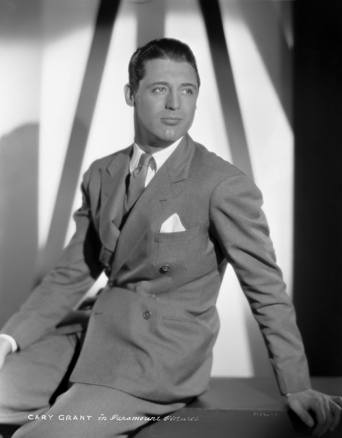 Cary Grant in a suit sitting down with a pocket chief H Photo Print - Item # VARCEL696058