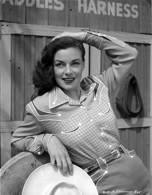 Marguerite Chapman Leaning in Casual Attire with a Smile Photo Print - Item # VARCEL696094