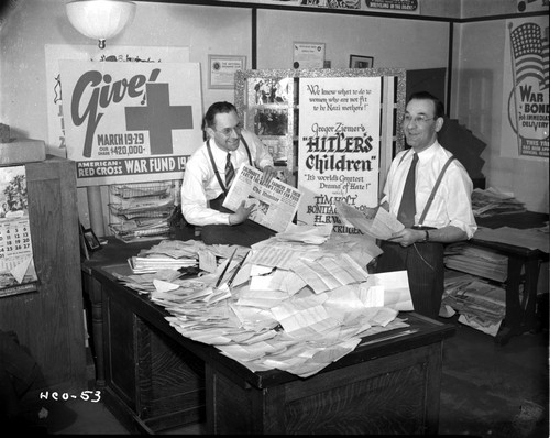 Two men with a pile of newspapers Photo Print - Item # VARCEL696122