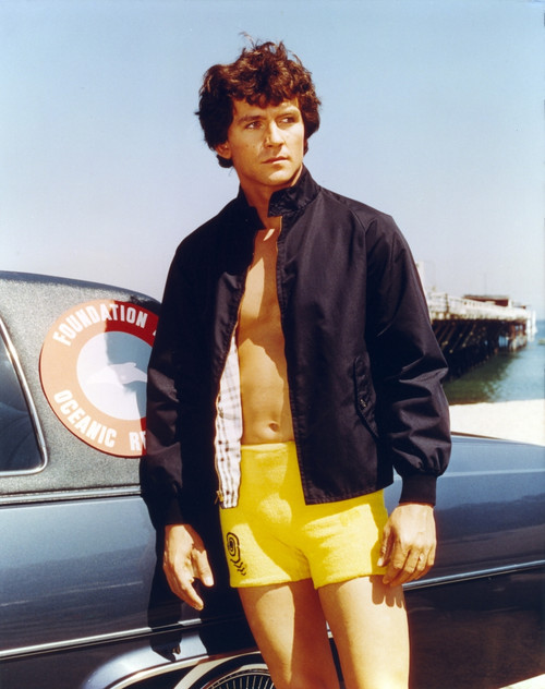 Patrick Duffy standing in Swimming Trunks with Black Jacket Photo Print - Item # VARCEL696262