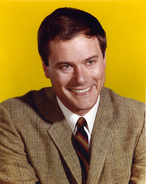 Larry Hagman smiling in Yellow Background Photo Print - Item # VARCEL696537