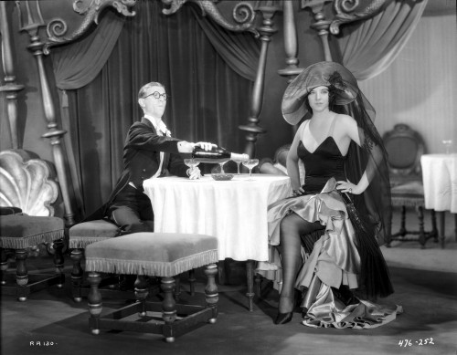 Bebe Daniels Having a Dinner with a Man in Black Strap Dress with Hands Laid on the Waist Photo Print - Item # VARCEL696668