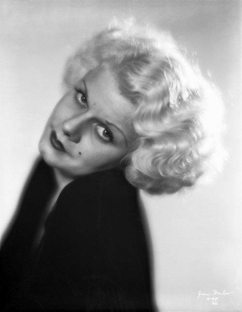 Jean Harlow Portrait in Black Deep V-Neck Velvet Dress with Head Leaning on Left Shoulder in White Background Photo Print - Item # VARCEL696786